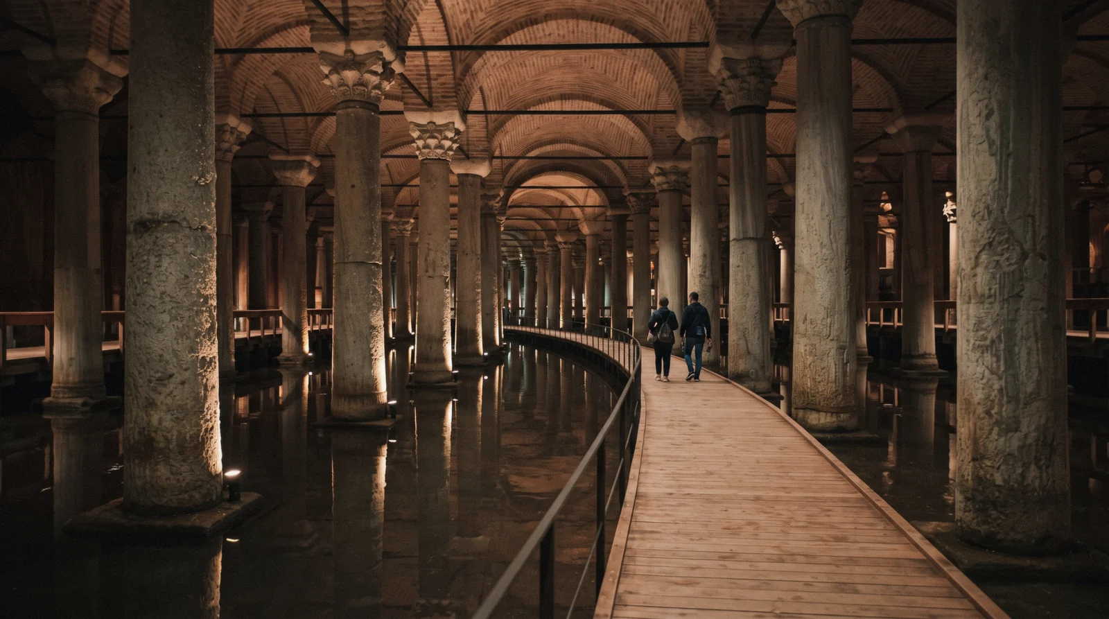 Lit columns reflected in the shallow water of the Basilica Cistern in Istanbul, Türkiye