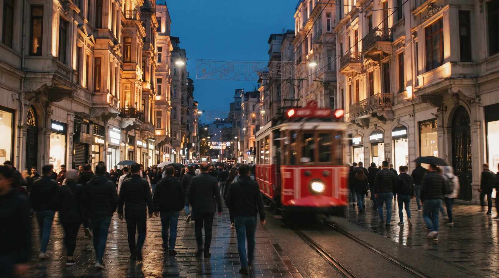 The red tram and evening crowds on Istiklal Street in Beyoglu, Istanbul, Türkiye