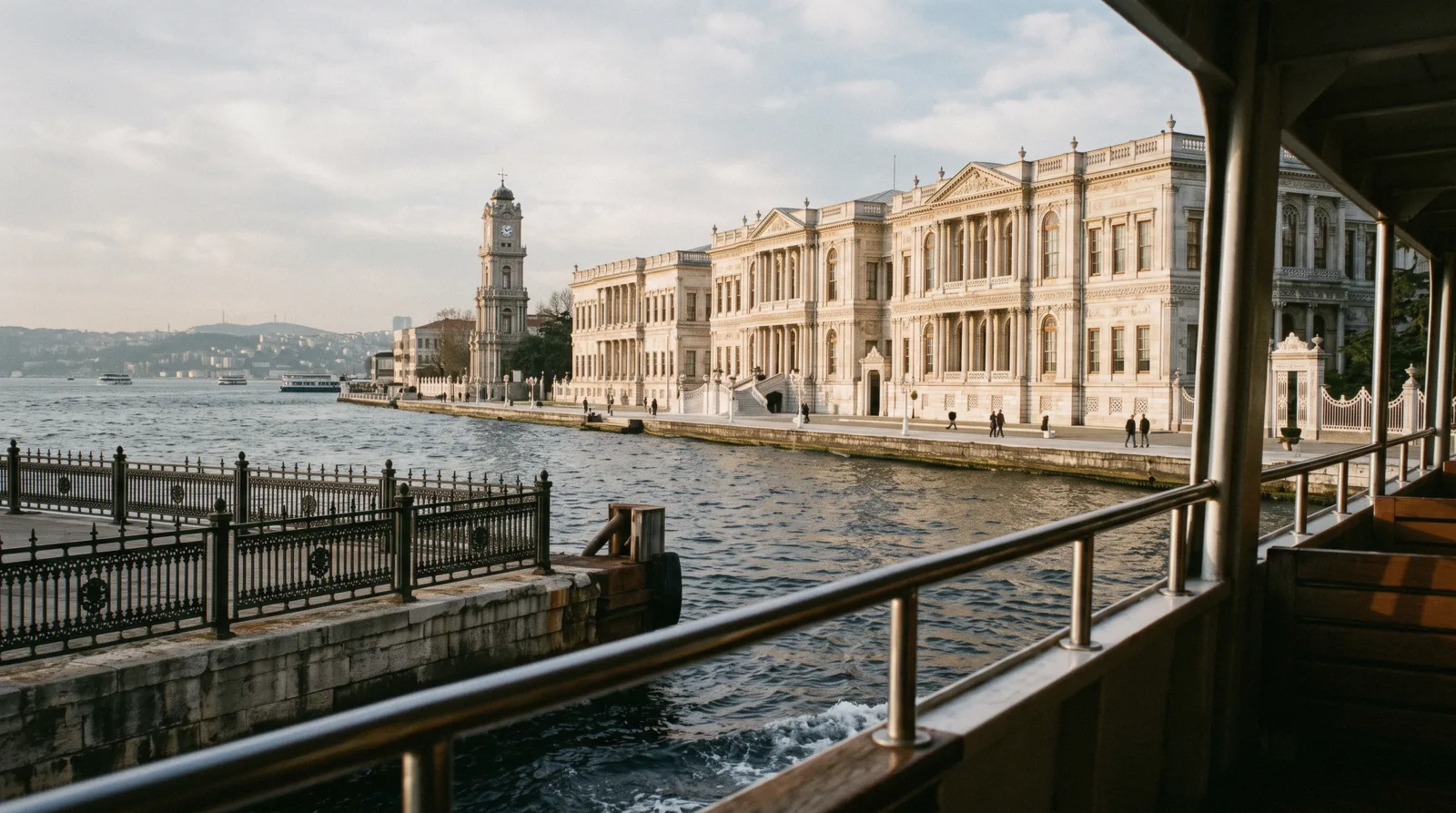 The waterfront facade and clock tower of Dolmabahce Palace on the Bosphorus in Istanbul, Türkiye