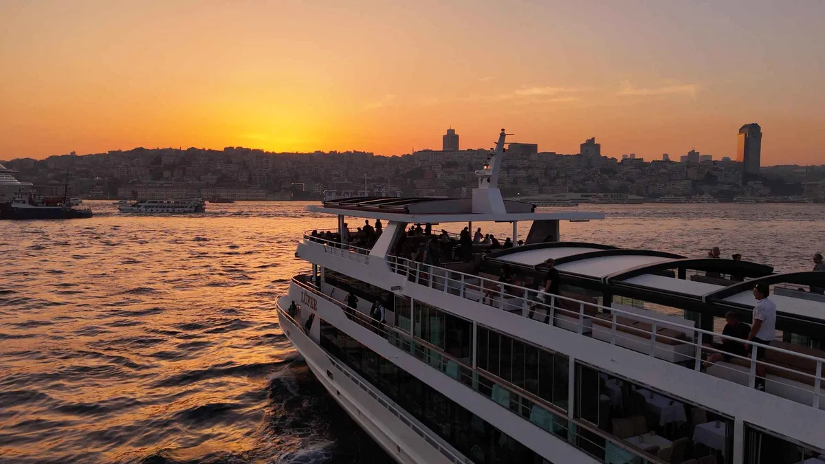 Sunset over the Bosphorus seen from the deck of a sightseeing boat in Istanbul, Türkiye